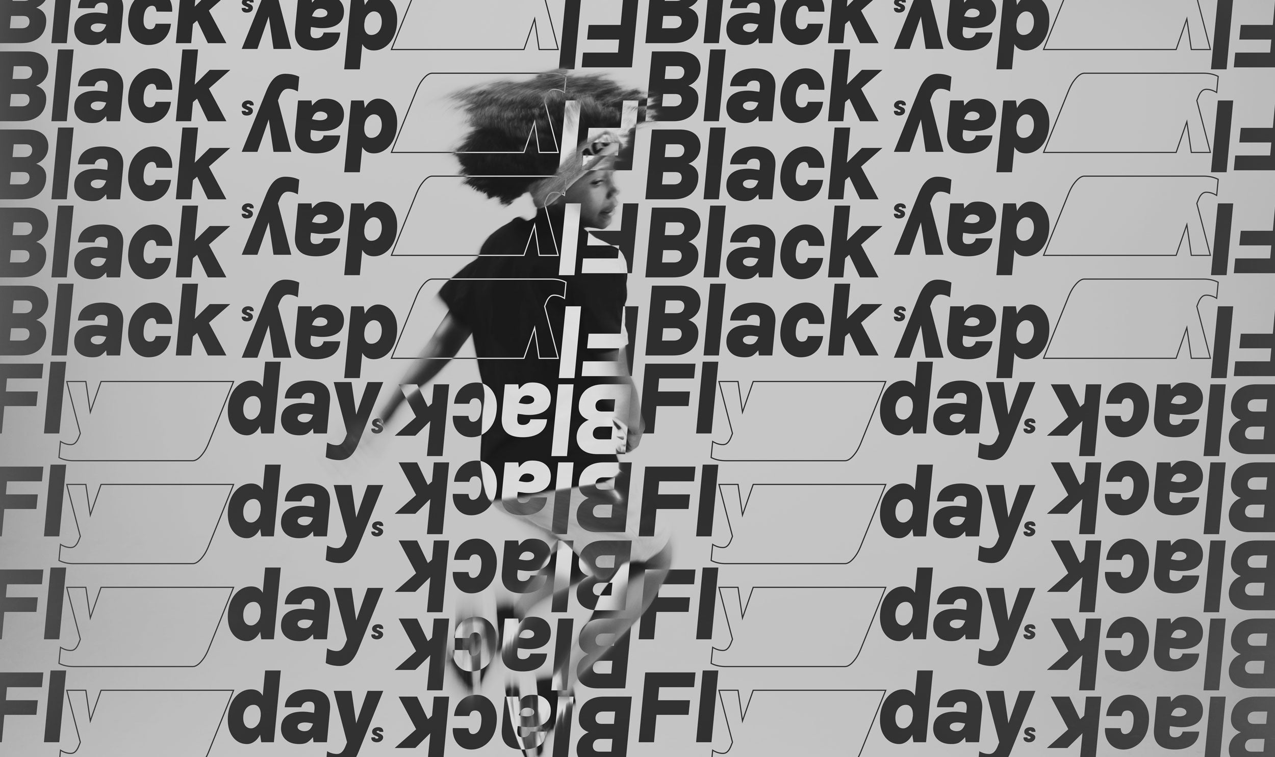 Mustavalkokuvassa pomppiva poika ja useita Black Flyday -tekstejä.